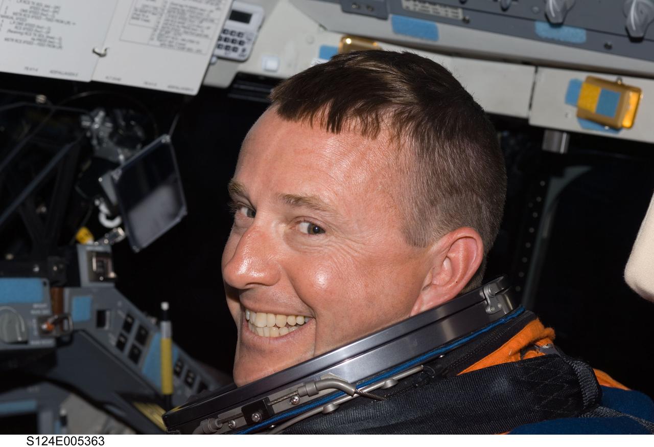 S124-E-005363 (31 May 2008) --- Attired in his shuttle launch and entry suit, astronaut Ken Ham, STS-124 pilot, takes a moment for a photo as he works at the pilot's station on the forward flight deck of Space Shuttle Discovery during flight day one activities.