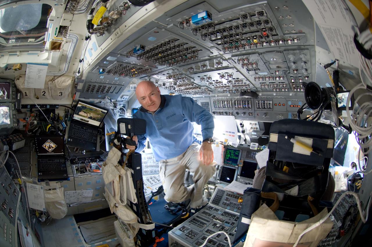 S124-E-005407 (1 June 2008) --- Astronaut Mark Kelly, STS-124 commander, takes a moment for a photo near the commander's station on the forward flight deck of Space Shuttle Discovery during flight day two activities.