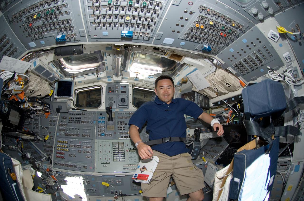 S124-E-005413 (1 June 2008) --- Japan Aerospace Exploration Agency (JAXA) astronaut Akihiko Hoshide, STS-124 mission specialist, takes a moment for a photo on the aft flight deck of Space Shuttle Discovery during flight day two activities.