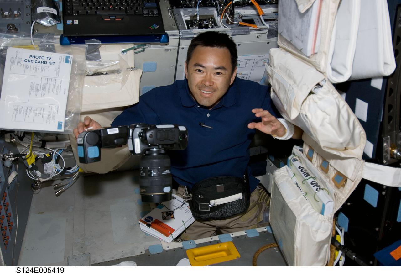 S124-E-005419 (1 June 2008) --- Japan Aerospace Exploration Agency (JAXA) astronaut Akihiko Hoshide, STS-124 mission specialist, smiles for a photo while in the hatch which connects the flight deck and middeck of Space Shuttle Discovery.
