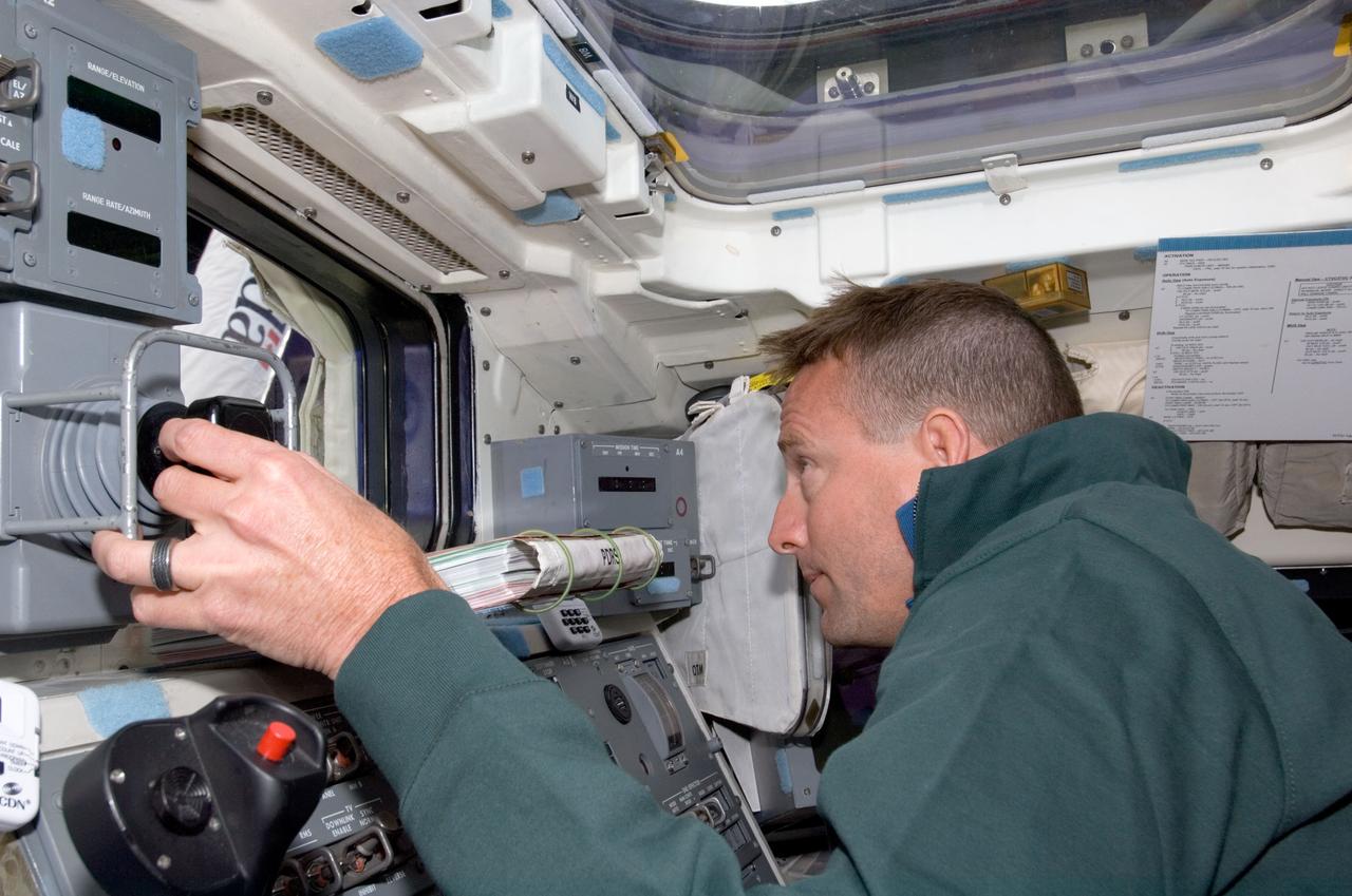S124-E-005436 (1 June 2008) --- Astronaut Ken Ham, STS-124 pilot, works the controls on the aft flight deck of Space Shuttle Discovery during flight day two activities.