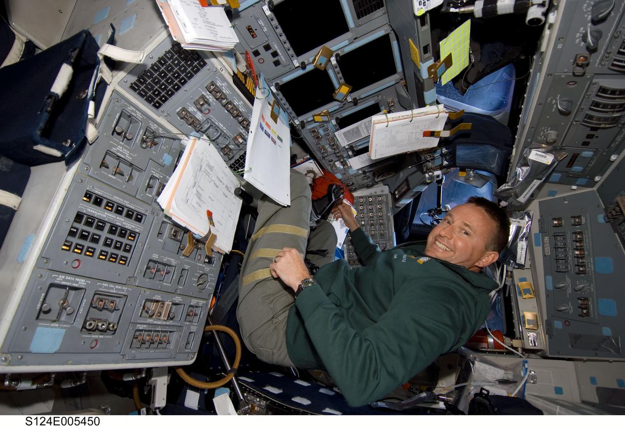 S124-E-005450 (1 June 2008) --- Astronaut Ken Ham, STS-124 pilot, smiles for a photo as he works at the pilot's station on the forward flight deck of Space Shuttle Discovery during flight day two activities.