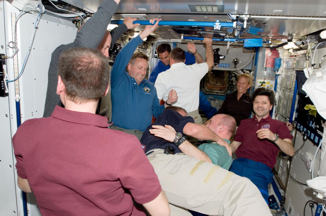 S124-E-005615 (2 June 2008) --- The STS-124 and Expedition 17 crewmembers greet each other shortly after Space Shuttle Discovery and the International Space Station docked in space and the hatches were opened on June 2, 2008. Pictured are Russian Federal Space Agency cosmonaut Sergei Volkov (left foreground), Expedition 17 commander; NASA astronauts Mark Kelly (left, partially obscured), STS-124 commander; Ken Ham, STS-124 pilot; Mike Fossum (center left), STS-124 mission specialist; Garrett Reisman (center right); cosmonaut Oleg Kononenko (right), both Expedition 17 flight engineers; astronaut Ron Garan, Greg Chamitoff and Karen Nyberg, all STS-124 mission specialists. Not pictured is Japan Aerospace Exploration Agency (JAXA) astronaut Akihiko Hoshide, STS-124 mission specialist.