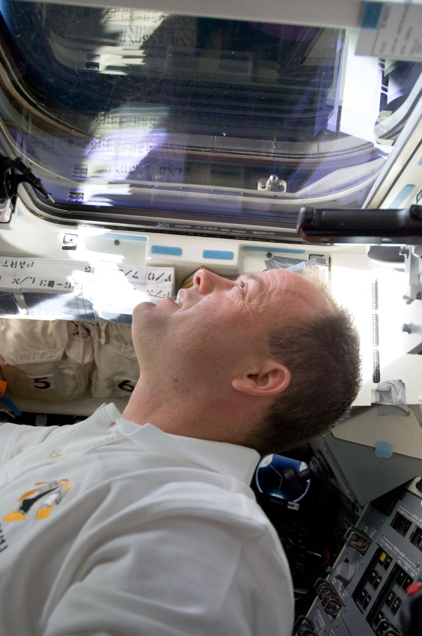 S124-E-005658 (2 June 2008) --- Astronaut Ron Garan, STS-124 mission specialist, looks out a window on the aft flight deck of the Space Shuttle Discovery during flight day three activities.