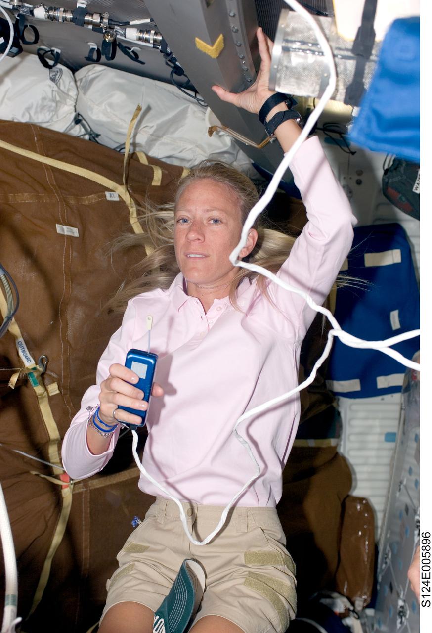 S124-E-005896 (3 June 2008) --- Astronaut Karen Nyberg, STS-124 mission specialist, uses a communication system on the middeck of Space Shuttle Discovery while docked with the International Space Station.