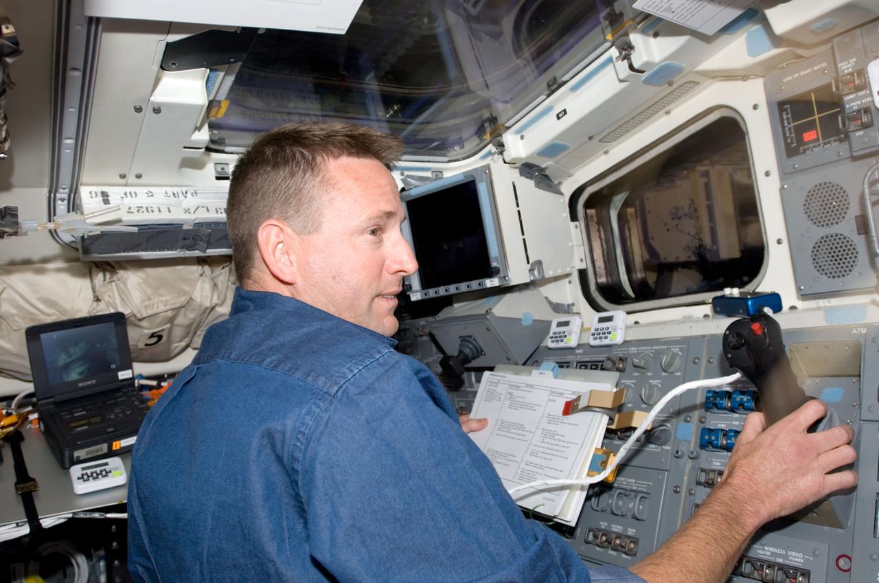 S124-E-006029 (3 June 2008) --- Astronaut Ken Ham, STS-124 pilot, works the controls on the aft flight deck of Space Shuttle Discovery while docked with the International Space Station.