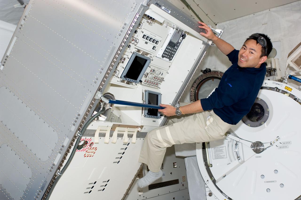 S124-E-006279 (4 June 2008) --- Japan Aerospace Exploration Agency (JAXA) astronaut Akihiko Hoshide, STS-124 mission specialist, smiles for a photo as he works in the newly installed Kibo Japanese Pressurized Module (JPM) of the International Space Station while Space Shuttle Discovery is docked with the station.