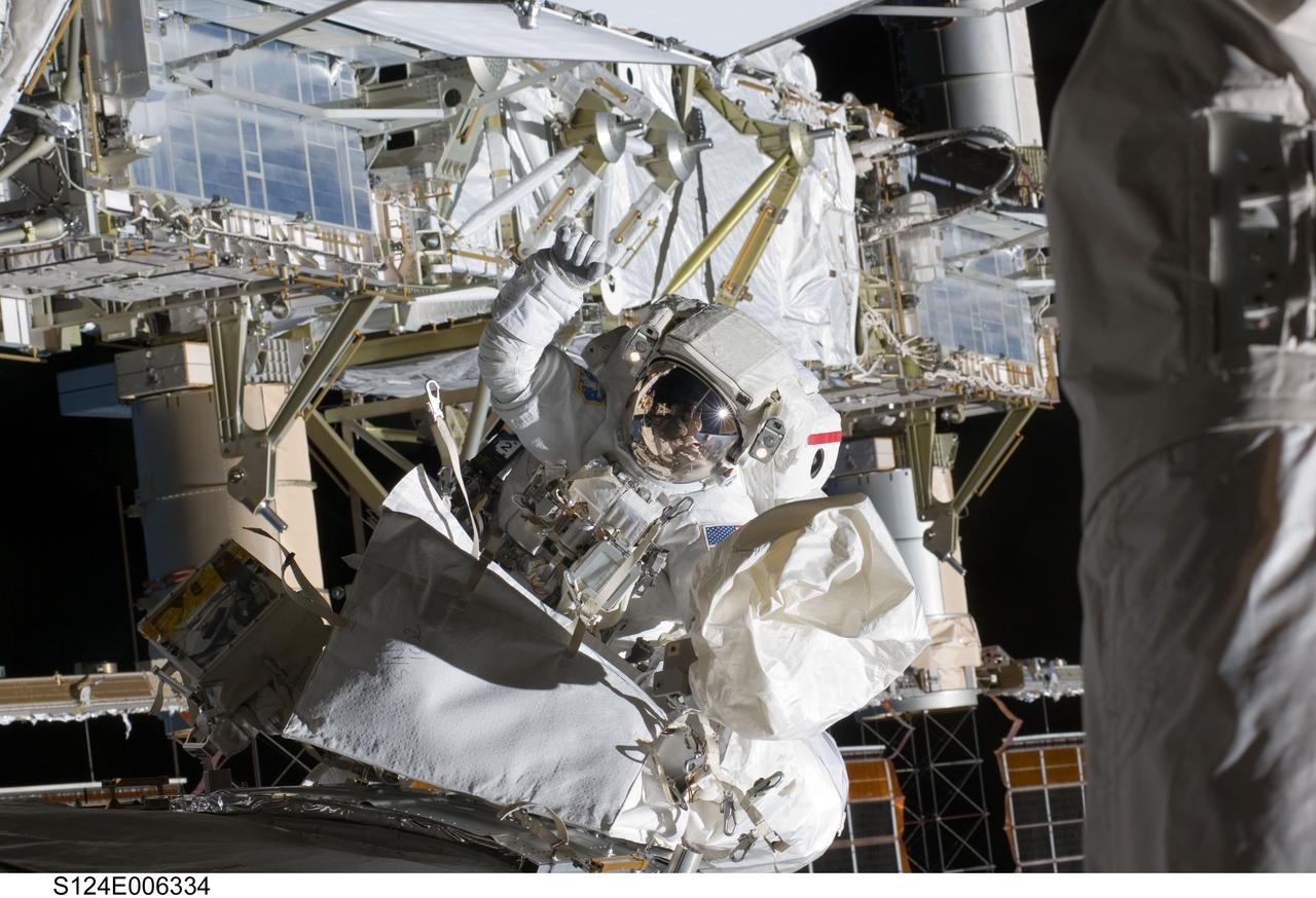 S124-E-006334 (5 June 2008) --- Astronaut Mike Fossum, STS-124 mission specialist, participates in the mission's second scheduled session of extravehicular activity (EVA) as construction and maintenance continue on the International Space Station. During the seven-hour, 11-minute spacewalk, Fossum and astronaut Ron Garan (out of frame), mission specialist, installed television cameras on the front and rear of the Kibo Japanese Pressurized Module (JPM) to assist Kibo robotic arm operations, removed thermal covers from the Kibo robotic arm, prepared an upper JPM docking port for flight day seven's attachment of the Kibo logistics module, readied a spare nitrogen tank assembly for its installation during the third spacewalk, retrieved a failed television camera from the Port 1 truss, and inspected the port Solar Alpha Rotary Joint (SARJ).