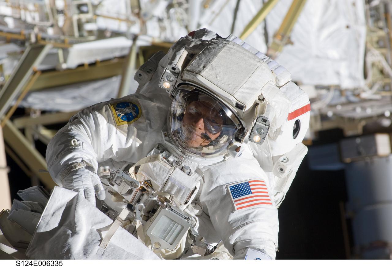 S124-E-006335 (5 June 2008) --- Astronaut Mike Fossum, STS-124 mission specialist, participates in the mission's second scheduled session of extravehicular activity (EVA) as construction and maintenance continue on the International Space Station. During the seven-hour, 11-minute spacewalk, Fossum and astronaut Ron Garan (out of frame), mission specialist, installed television cameras on the front and rear of the Kibo Japanese Pressurized Module (JPM) to assist Kibo robotic arm operations, removed thermal covers from the Kibo robotic arm, prepared an upper JPM docking port for flight day seven's attachment of the Kibo logistics module, readied a spare nitrogen tank assembly for its installation during the third spacewalk, retrieved a failed television camera from the Port 1 truss, and inspected the port Solar Alpha Rotary Joint (SARJ).