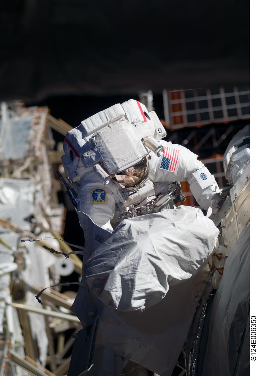 S124-E-006350 (5 June 2008) --- Astronaut Mike Fossum, STS-124 mission specialist, participates in the mission's second scheduled session of extravehicular activity (EVA) as construction and maintenance continue on the International Space Station. During the seven-hour, 11-minute spacewalk, Fossum and astronaut Ron Garan (out of frame), mission specialist, installed television cameras on the front and rear of the Kibo Japanese Pressurized Module (JPM) to assist Kibo robotic arm operations, removed thermal covers from the Kibo robotic arm, prepared an upper JPM docking port for flight day seven's attachment of the Kibo logistics module, readied a spare nitrogen tank assembly for its installation during the third spacewalk, retrieved a failed television camera from the Port 1 truss, and inspected the port Solar Alpha Rotary Joint (SARJ).