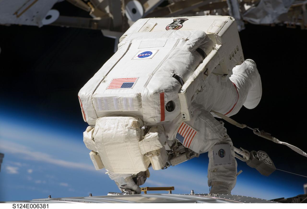 S124-E-006381 (5 June 2008) --- Astronaut Mike Fossum, STS-124 mission specialist, participates in the mission's second scheduled session of extravehicular activity (EVA) as construction and maintenance continue on the International Space Station. During the seven-hour, 11-minute spacewalk, Fossum and astronaut Ron Garan (out of frame), mission specialist, installed television cameras on the front and rear of the Kibo Japanese Pressurized Module (JPM) to assist Kibo robotic arm operations, removed thermal covers from the Kibo robotic arm, prepared an upper JPM docking port for flight day seven's attachment of the Kibo logistics module, readied a spare nitrogen tank assembly for its installation during the third spacewalk, retrieved a failed television camera from the Port 1 truss, and inspected the port Solar Alpha Rotary Joint (SARJ).