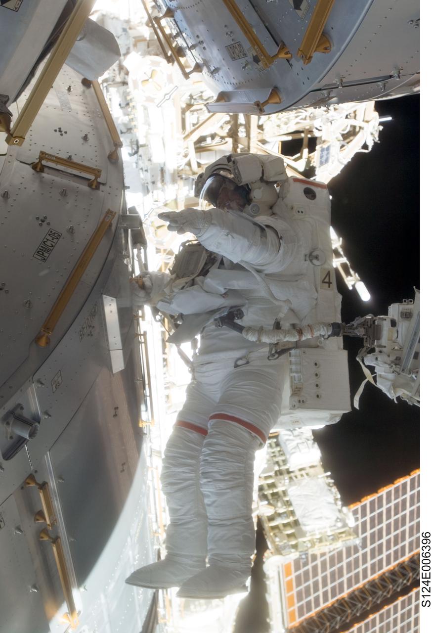 S124-E-006396 (5 June 2008) --- Astronaut Mike Fossum, STS-124 mission specialist, participates in the mission's second scheduled session of extravehicular activity (EVA) as construction and maintenance continue on the International Space Station. During the seven-hour, 11-minute spacewalk, Fossum and astronaut Ron Garan (out of frame), mission specialist, installed television cameras on the front and rear of the Kibo Japanese Pressurized Module (JPM) to assist Kibo robotic arm operations, removed thermal covers from the Kibo robotic arm, prepared an upper JPM docking port for flight day seven's attachment of the Kibo logistics module, readied a spare nitrogen tank assembly for its installation during the third spacewalk, retrieved a failed television camera from the Port 1 truss, and inspected the port Solar Alpha Rotary Joint (SARJ).