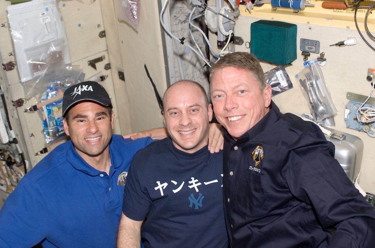 S124-E-006703 (6 June 2008) --- From the left, astronauts Greg Chamitoff, Expedition 17 flight engineer, Garrett Reisman, newly transferred from ISS duty to mission specialist duty on STS-124, and Mike Fossum, STS-124 mission specialist, enjoy one of the more leisurely moments onboard the busy International Space Station. As evidenced by food items and utensils on the nearby walls, at least part of the leisure time was devoted to eating.