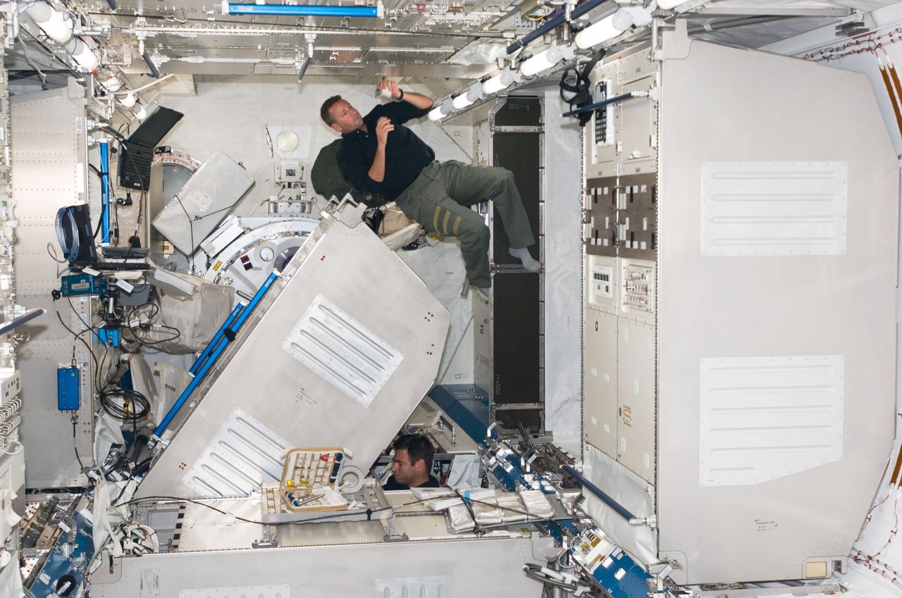 S124-E-006792 (6 June 2008) --- Astronauts Ken Ham (top), STS-124 pilot, and Greg Chamitoff, Expedition 17 flight engineer, work in the newly installed Kibo Japanese Pressurized Module of the International Space Station while Space Shuttle Discovery is docked with the station.
