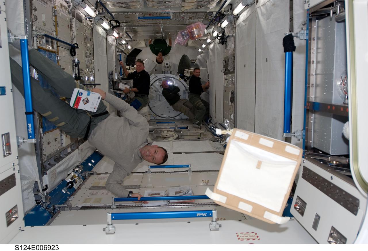 S124-E-006923 (6 June 2008) --- Astronauts Ron Garan (foreground), Mike Fossum (left background), Japan Aerospace Exploration Agency astronaut Akihiko Hoshide (top background), all STS-124 mission specialists; astronaut Mark Kelly (bottom background) and Ken Ham, commander and pilot, respectively, work in the newly installed Kibo Japanese Pressurized Module while Space Shuttle Discovery is docked with the station.