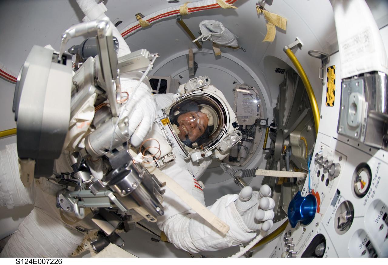 S124-E-007226 (8 June 2008) --- A "fish-eye" lens on a digital still camera was used to record this image of astronaut Ron Garan, STS-124 mission specialist, in the Quest Airlock of the International Space Station while Space Shuttle Discovery is docked with the station. Garan and astronaut Mike Fossum (out of frame) were about to begin the mission's third scheduled spacewalk.