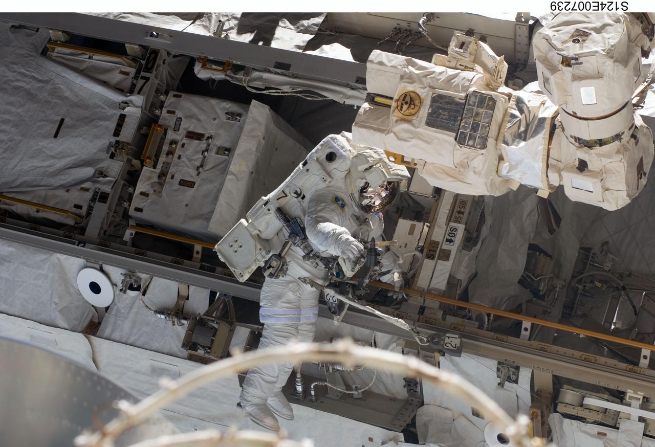 S124-E-007239 (8 June 2008) --- Astronaut Ron Garan, STS-124 mission specialist, participates in the mission's third scheduled session of extravehicular activity (EVA) as construction and maintenance continue on the International Space Station. During the six-hour, 33-minute spacewalk, Garan and astronaut Mike Fossum (out of frame), mission specialist, exchanged a depleted Nitrogen Tank Assembly for a new one, removed thermal covers and launch locks from the Kibo laboratory, reinstalled a repaired television camera onto the space station's left P1 truss, and retrieved samples of a dust-like substance from the left Solar Alpha Rotary Joint for analysis by experts on the ground.