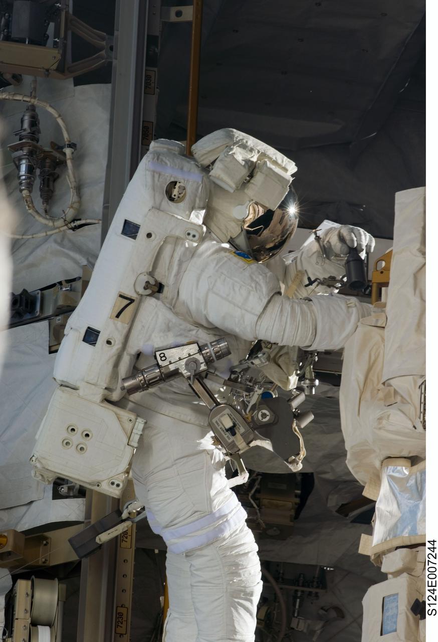 S124-E-007244 (8 June 2008) --- Astronaut Ron Garan, STS-124 mission specialist, participates in the mission's third scheduled session of extravehicular activity (EVA) as construction and maintenance continue on the International Space Station. During the six-hour, 33-minute spacewalk, Garan and astronaut Mike Fossum (out of frame), mission specialist, exchanged a depleted Nitrogen Tank Assembly for a new one, removed thermal covers and launch locks from the Kibo laboratory, reinstalled a repaired television camera onto the space station's left P1 truss, and retrieved samples of a dust-like substance from the left Solar Alpha Rotary Joint for analysis by experts on the ground.