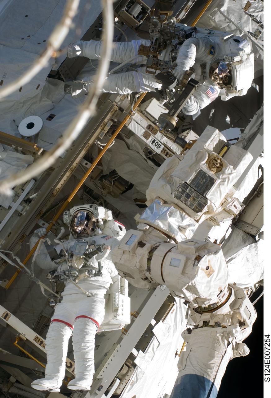 S124-E-007254 (8 June 2008) --- Astronauts Mike Fossum (bottom) and Ron Garan, both STS-124 mission specialists, participate in the mission's third scheduled session of extravehicular activity (EVA) as construction and maintenance continue on the International Space Station. During the six-hour, 33-minute spacewalk, Fossum and Garan exchanged a depleted Nitrogen Tank Assembly for a new one, removed thermal covers and launch locks from the Kibo laboratory, reinstalled a repaired television camera onto the space station's left P1 truss, and retrieved samples of a dust-like substance from the left Solar Alpha Rotary Joint for analysis by experts on the ground.