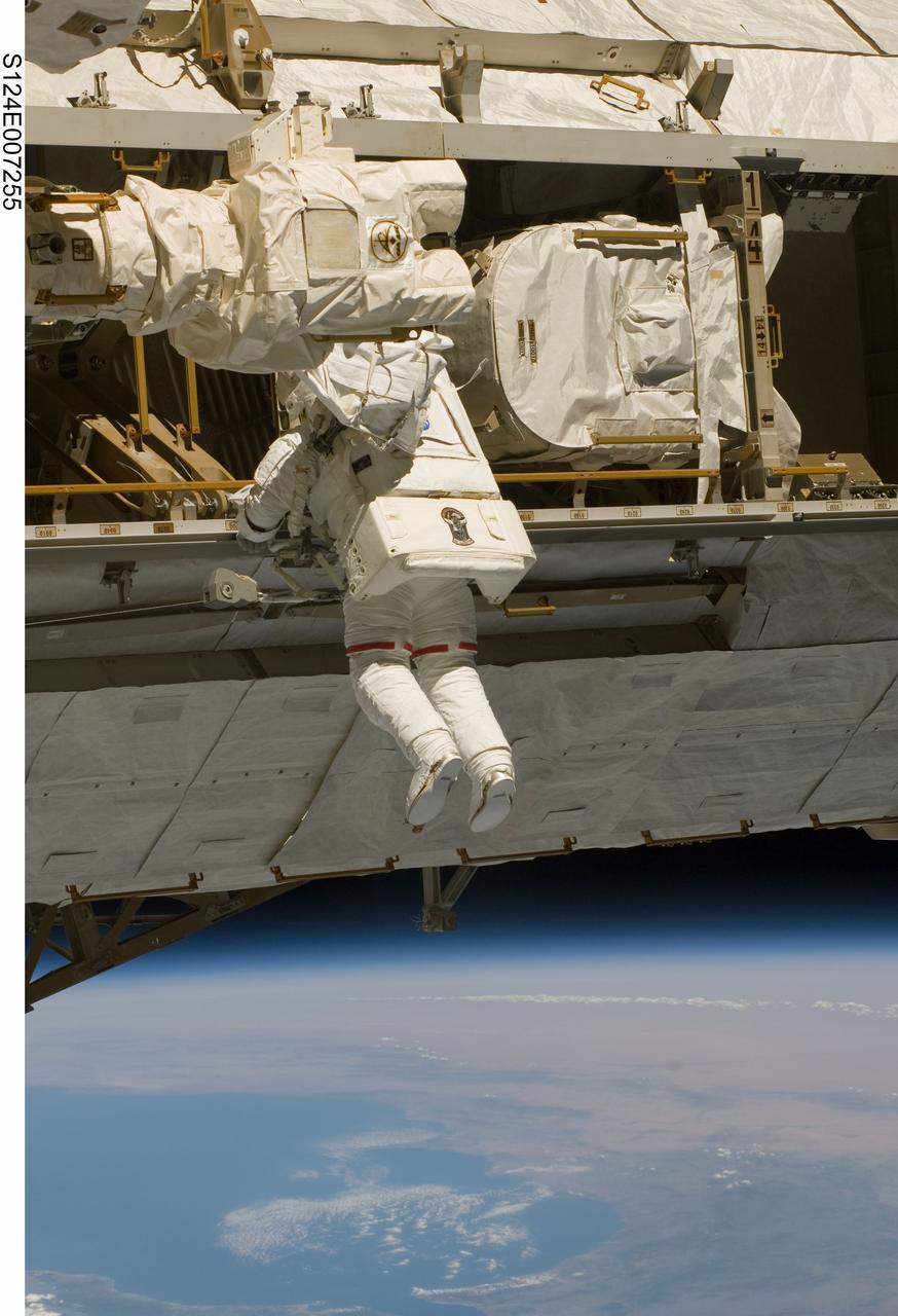 S124-E-007255 (8 June 2008) --- Astronaut Mike Fossum, STS-124 mission specialist, participates in the mission's third scheduled session of extravehicular activity (EVA) as construction and maintenance continue on the International Space Station. During the six-hour, 33-minute spacewalk, Fossum and astronaut Ron Garan (out of frame), mission specialist, exchanged a depleted Nitrogen Tank Assembly for a new one, removed thermal covers and launch locks from the Kibo laboratory, reinstalled a repaired television camera onto the space station's left P1 truss, and retrieved samples of a dust-like substance from the left Solar Alpha Rotary Joint for analysis by experts on the ground.