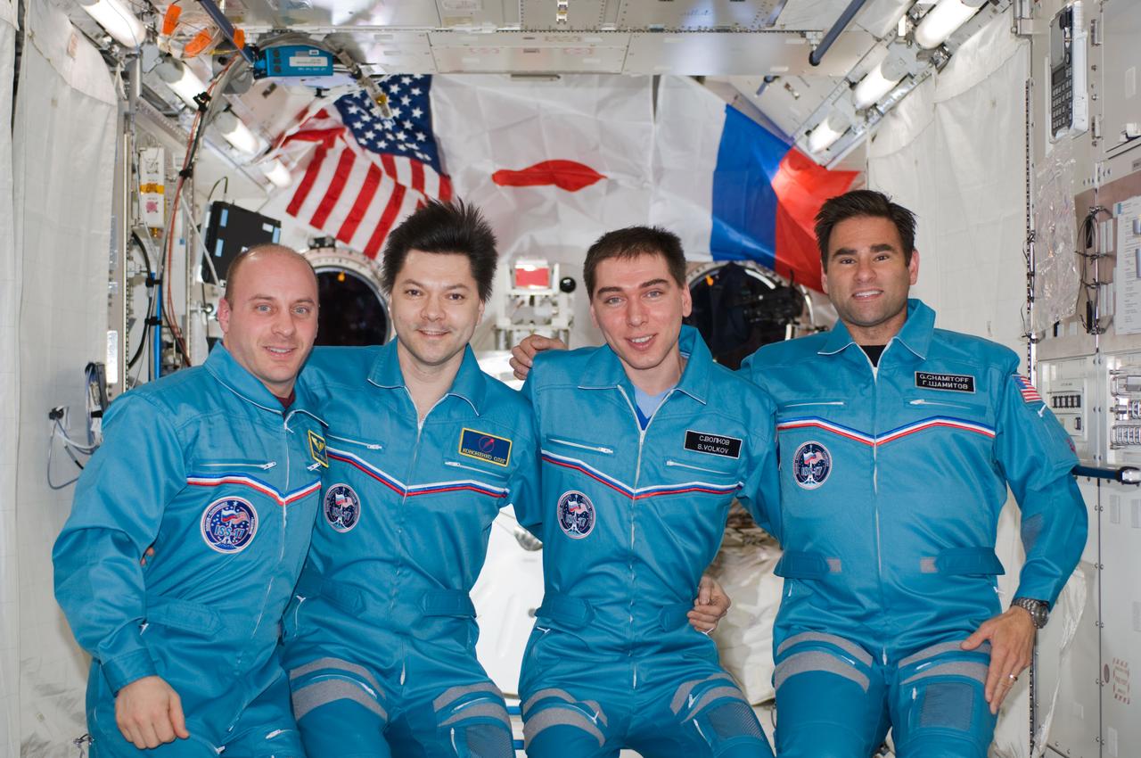 S124-E-007918 (9 June 2008) --- Russian Federal Space Agency cosmonauts Sergei Volkov (second right) and Oleg Kononenko (second left), Expedition 17 commander and flight engineer, respectively; along with NASA astronauts Greg Chamitoff (right), Expedition 17 flight engineer, and Garrett Reisman, STS-124 mission specialist, pose for a portrait following a joint news conference from the Kibo Japanese Pressurized Module of the International Space Station while Space Shuttle Discovery is docked with the station. Reisman, who joined the station's crew in March, is being replaced by Chamitoff, who arrived at the station with the STS-124 crew.