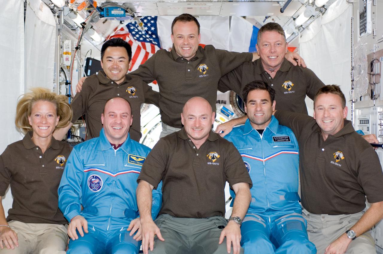 S124-E-007922 (9 June 2008) --- STS-124 crewmembers pose for a portrait following a joint news conference with the Expedition 17 crewmembers from the Kibo Japanese Pressurized Module of the International Space Station while Space Shuttle Discovery is docked with the station. From the left (front row) are NASA astronauts Karen Nyberg, Garrett Reisman, both mission specialists; Mark Kelly, commander; Greg Chamitoff, Expedition 17 flight engineer; and Ken Ham, pilot. From the left (back row) are Japan Aerospace Exploration Agency astronaut Akihiko Hoshide, NASA astronauts Ron Garan and Mike Fossum, all mission specialists. Reisman, who joined the station's crew in March, is being replaced by Chamitoff, who arrived at the station with the STS-124 crew.