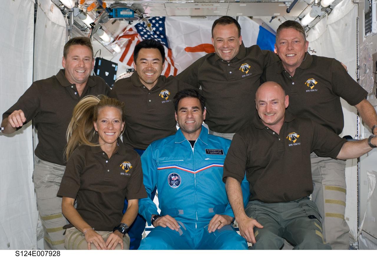S124-E-007928 (9 June 2008) --- STS-124 crewmembers and NASA astronaut Greg Chamitoff (center front row), Expedition 17 flight engineer, pose for a portrait following a joint news conference with the Expedition 17 crewmembers from the Kibo Japanese Pressurized Module of the International Space Station while Space Shuttle Discovery is docked with the station. Also pictured on the front row are NASA astronauts Karen Nyberg, mission specialist, and Mark Kelly, commander. From the left (back row) are NASA astronaut Ken Ham, pilot; Japan Aerospace Exploration Agency astronaut Akihiko Hoshide, NASA astronauts Ron Garan and Mike Fossum, all mission specialists. Reisman (not pictured), who joined the station's crew in March, is being replaced by Chamitoff, who arrived at the station with the STS-124 crew.
