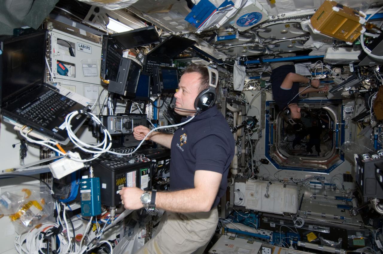 S124-E-009836 (10 June 2008) --- Astronaut Ron Garan, STS-124 mission specialist, uses a communication system in the Destiny laboratory of the International Space Station while Space Shuttle Discovery is docked with the station.