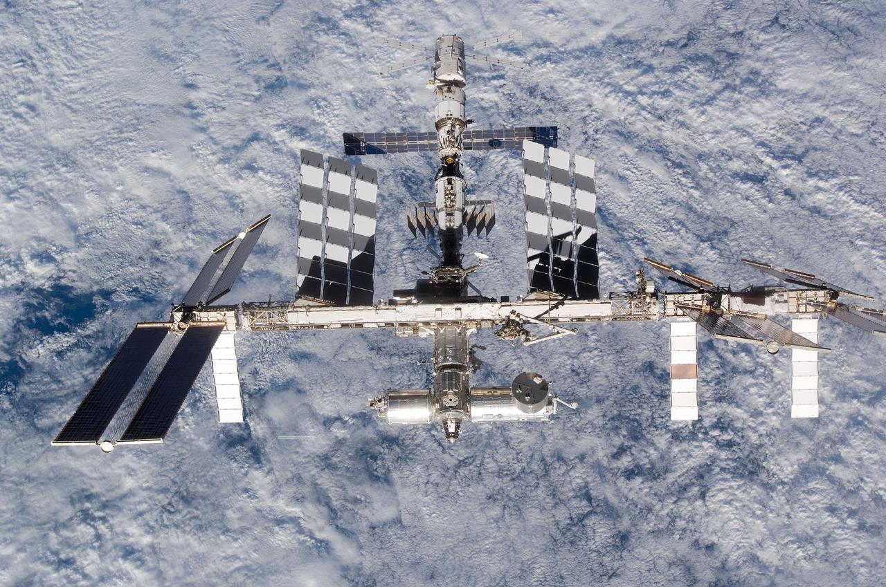 S124-E-009968 (11 June 2008) --- Backdropped by a cloud-covered part of Earth, the International Space Station is seen from Space Shuttle Discovery as the two spacecraft begin their relative separation. Earlier the STS-124 and Expedition 17 crews concluded almost nine days of cooperative work onboard the shuttle and station. Undocking of the two spacecraft occurred at 6:42 a.m. (CDT) on June 11, 2008.