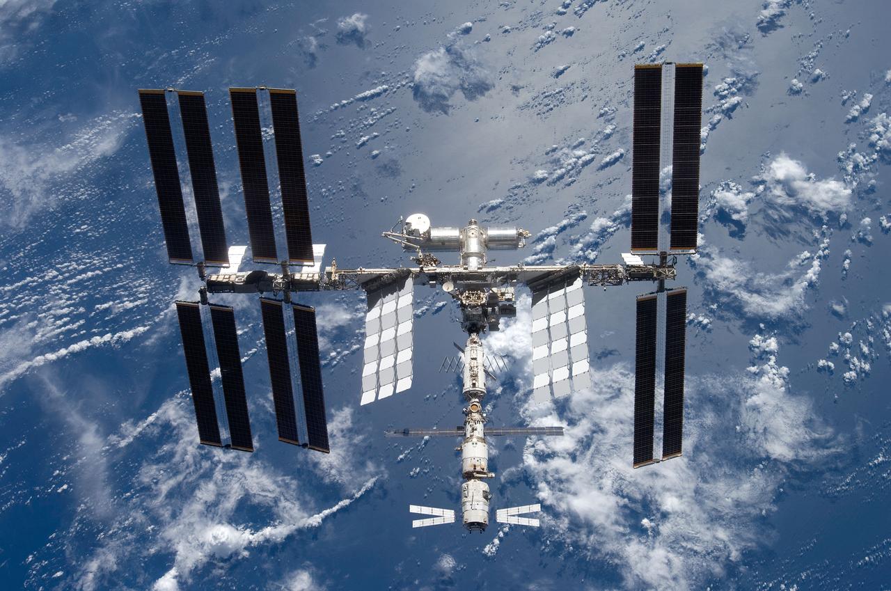 S124-E-009982 (11 June 2008) --- Backdropped by a blue and white part of Earth, the International Space Station is seen from Space Shuttle Discovery as the two spacecraft begin their relative separation. Earlier the STS-124 and Expedition 17 crews concluded almost nine days of cooperative work onboard the shuttle and station. Undocking of the two spacecraft occurred at 6:42 a.m. (CDT) on June 11, 2008.