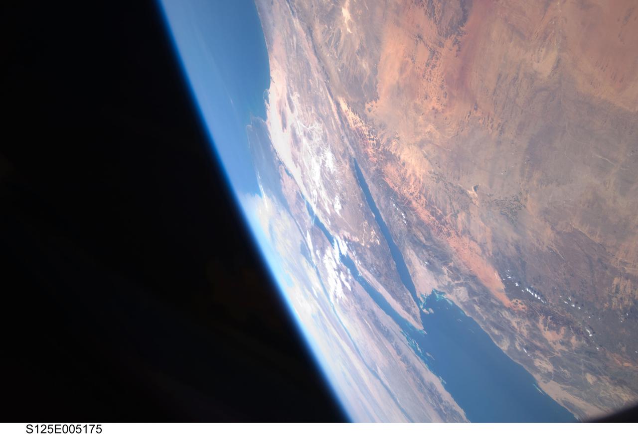 S125-E-005175 (12 May 2009) --- Among the first group of still images downlinked by the STS-125 crewmembers onboard the Space Shuttle Atlantis was this high oblique scene looking toward the Red Sea, Sinai Peninsula and the  Mediterranean Sea.  Saudi Arabia is in the foreground and Egypt?s  Nile River and its delta can be seen (left) toward the horizon.  Israel and Jordan can be seen near the top edge of the frame.  The Gulf of Suez and the Gulf of Aqaba (near frame center) extend from the Red Sea toward the Mediterranean Sea.
