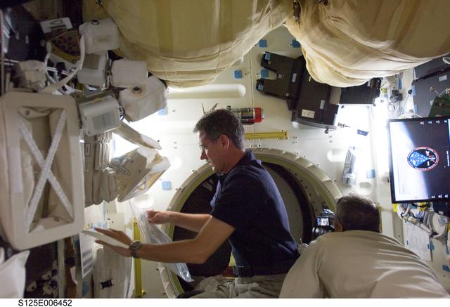 STS-125 Crew Members in the Shuttle Middeck