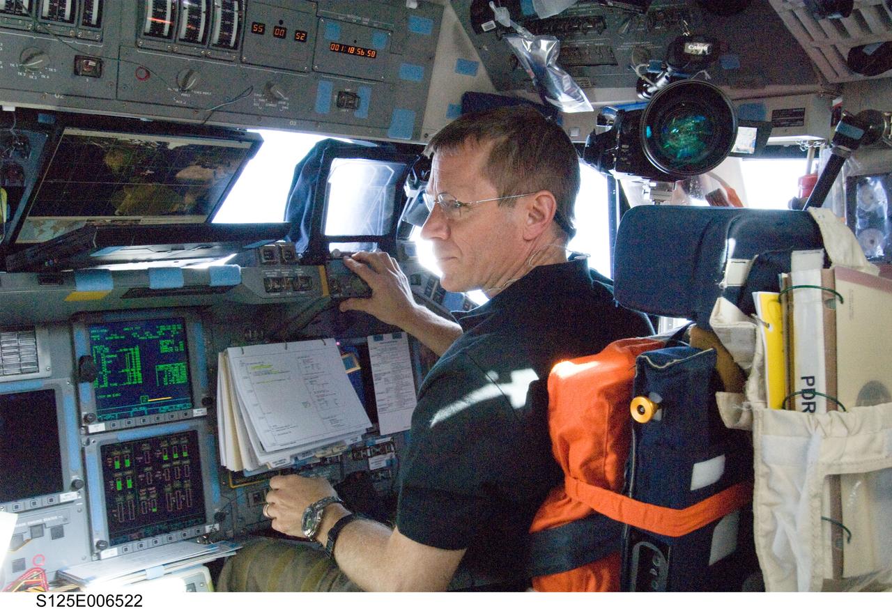 S125-E-006522 (13 May 2009) --- Astronaut Gregory C. Johnson, STS-125 pilot, occupies the pilot?s station on the flight deck of the Earth-orbiting Space Shuttle Atlantis during flight day three activities.