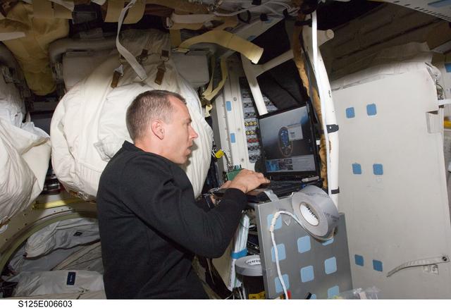 NASA image: Feustel working on a Laptop on the Shuttle Atlantis Middeck