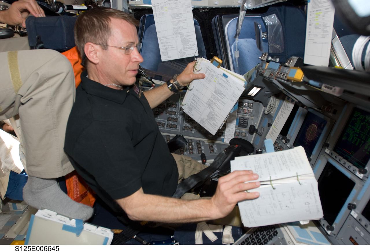 S125-E-006645 (13 May 2009) --- Astronaut Gregory C. Johnson, STS-125 pilot, occupies the commander?s station on the flight deck of Space Shuttle Atlantis during flight day three activities.