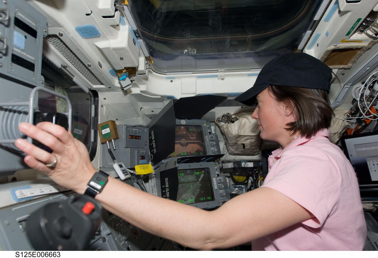 S125-E-006663 (13 May 2009) --- Astronaut Megan McArthur, STS-125 mission specialist, works the controls of Space Shuttle Atlantis? remote manipulator system (RMS) robotic arm on the aft flight deck during the flight day three activities.