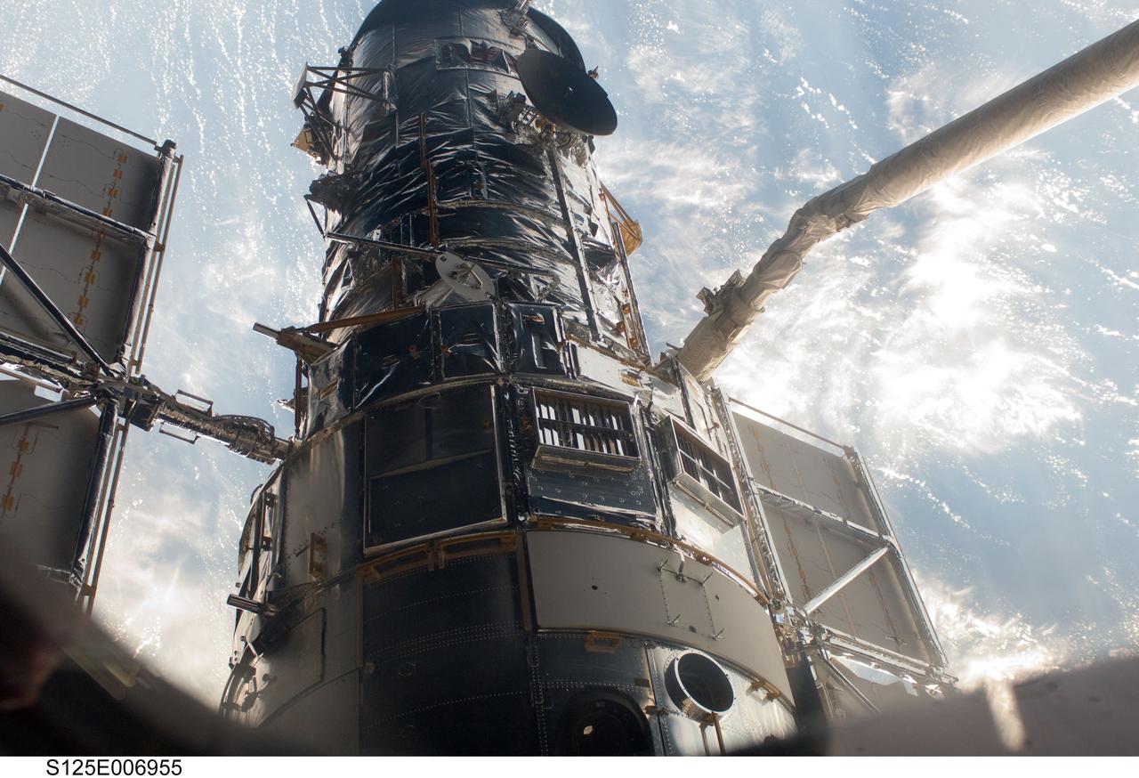 S125-E-006955 (13 May 2009) ---  An STS-125 crewmember onboard the Space Shuttle Atlantis snapped a still photo of the Hubble Space Telescope following grapple of the giant observatory by the shuttle?s Canadian-built remote manipulator system.