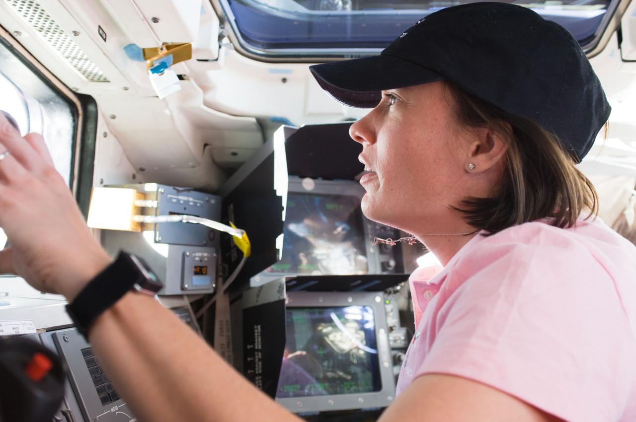 S125-E-007000 (13 May 2009) --- Astronaut Megan McArthur, STS-125 mission specialist, works the controls of Space Shuttle Atlantis? remote manipulator system (RMS) robotic arm on the aft flight deck during the flight day three activities.