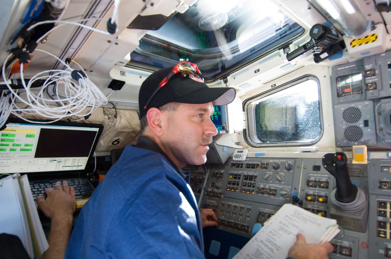 S125-E-007006 (13 May 2009) --- Astronaut John Grunsfeld, STS-125 mission specialist, works on the aft flight deck of Space Shuttle Atlantis during flight day three activities.