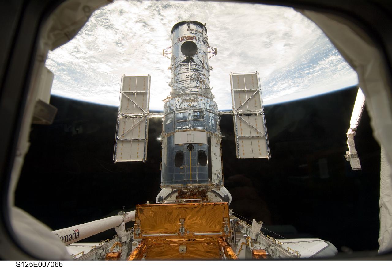 S125-E-007066 (13 May 2009) --- The Hubble Space Telescope stands tall in the cargo bay of the Space Shuttle Atlantis following its capture and lock-down in Earth orbit