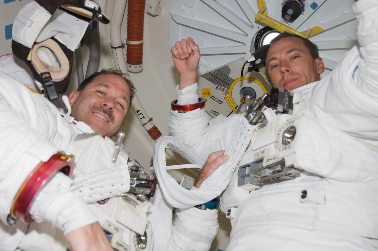 S125-E-007182 (14 May 2009) --- Astronauts John Grunsfeld (left) and Andrew Feustel, STS-125 mission specialists, made up the May 14 team of space walkers assigned to begin the final work on the Hubble Space Telescope. They will share two more sessions of extravehicular session later in the week.