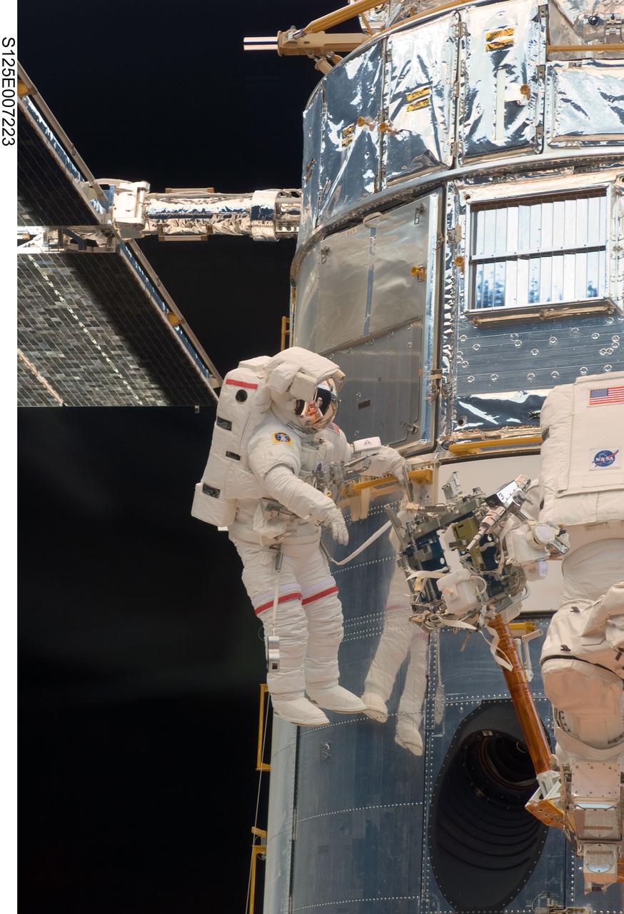 S125-E-007223 (14 May 2009) --- Astronaut John Grunsfeld performs work on the Hubble Space Telescope as the first of five STS-125 spacewalks kicks off a week?s worth of work on the orbiting observatory.  Grunsfeld, a spacewalk veteran with a long relationship with the telescope, will participate in two of the remaining four sessions of extravehicular activity later in the mission.