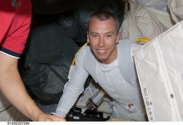 NASA image: View of MS5 Feustel posing for a photo in the Middeck prior to EVA1