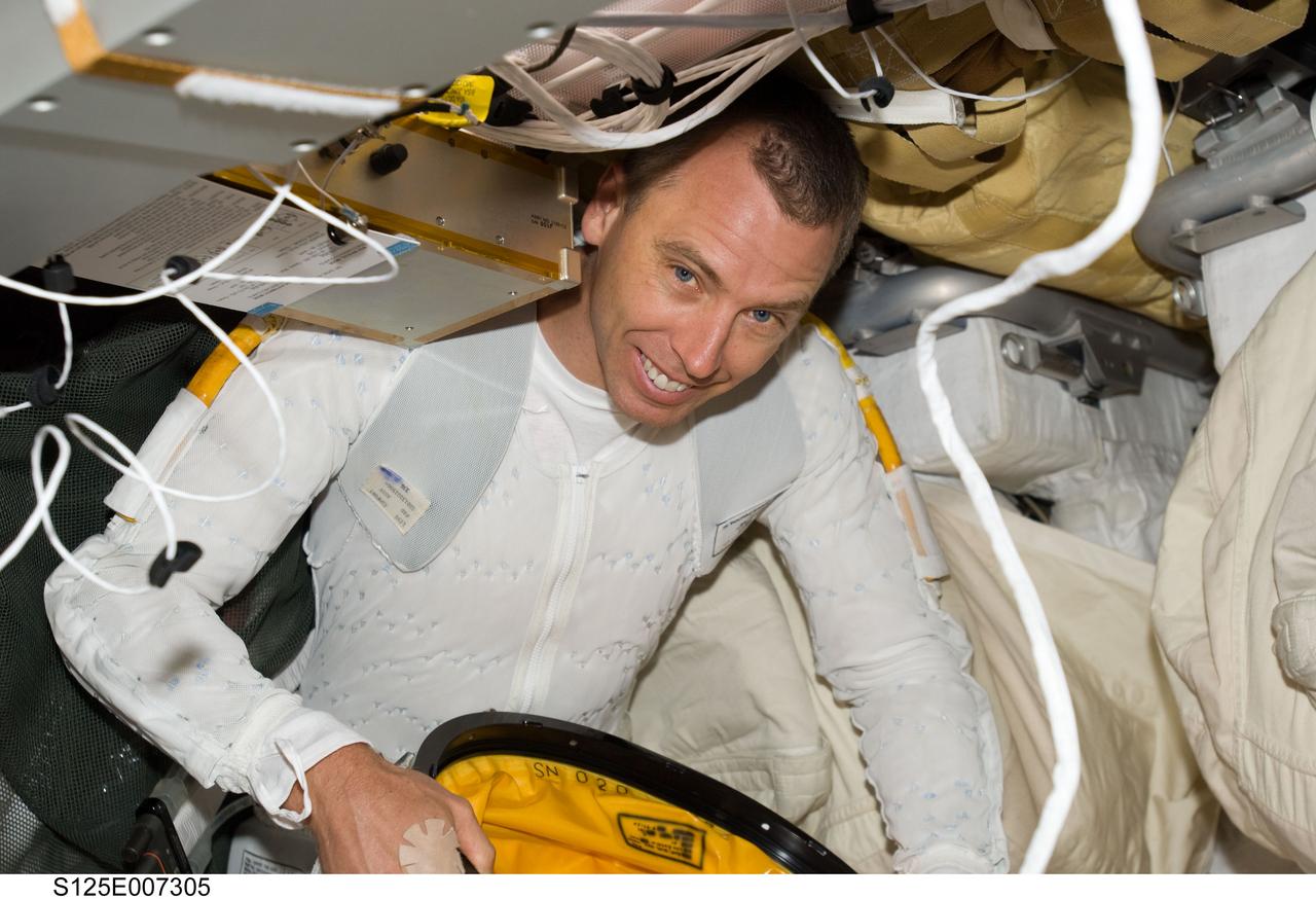S125-E-007305 (14 May 2009) --- Astronaut Andrew Feustel, STS-125 mission specialist, wearing the liquid cooling and ventilation garment that complements the Extravehicular Mobility Unit (EMU) spacesuit, is pictured on the middeck of Space Shuttle Atlantis prior to the mission?s first session of extravehicular activity (EVA).