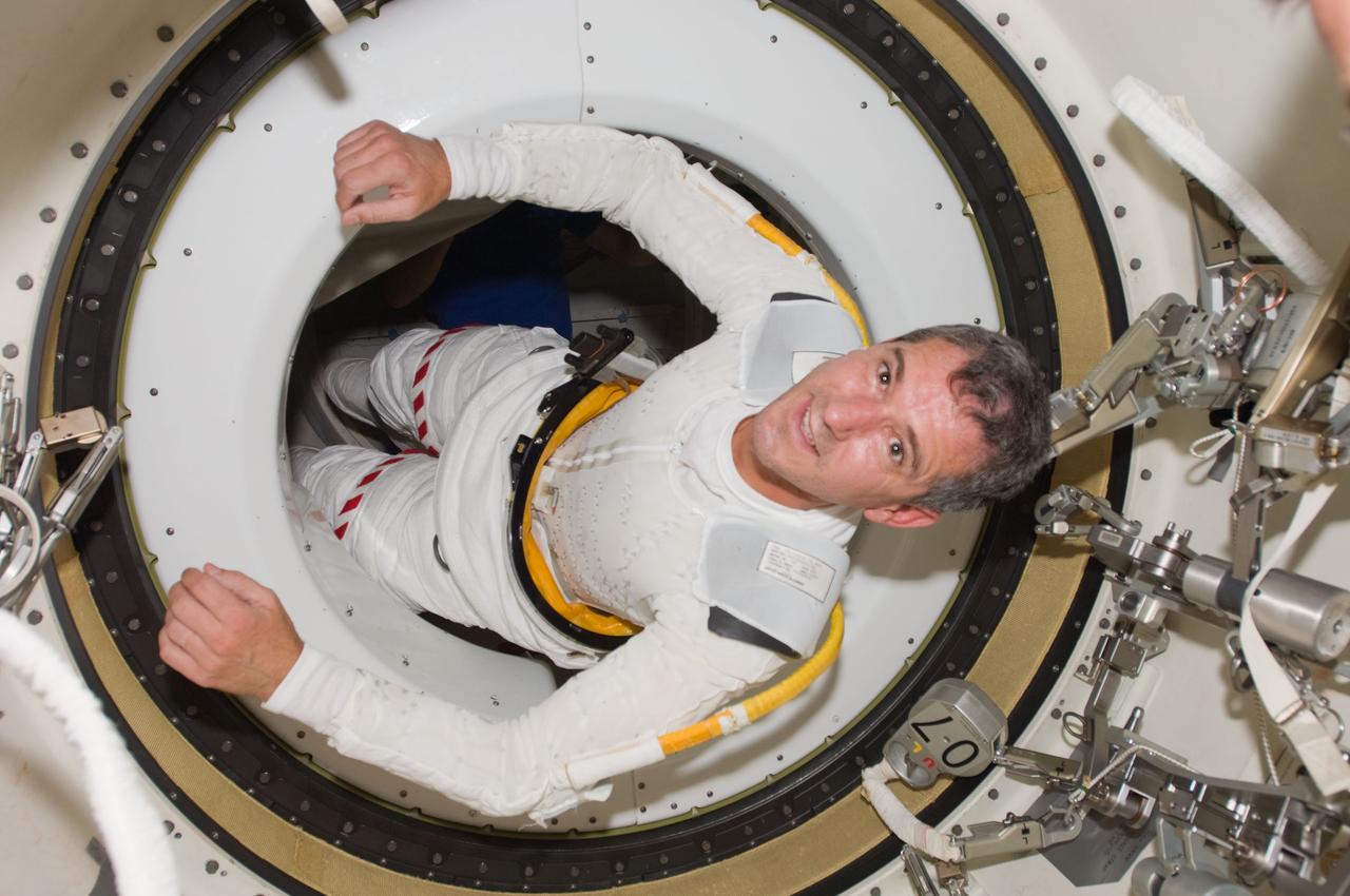 S125-E-007803 (15 May 2009) --- Judging by his countenance, astronaut Michael Good onboard the Space Shuttle Atlantis is enjoying his first experience not only in space but in participating in a very important space walk, as well.  The mission specialist is lacking the gloves, helmet and outer torso part of the extravehicular mobility unit space suit, but he is wearing the pants portion. Astronauts Good and Mike Massimino successfully completed the second of five scheduled sessions of extravehicular activity for this crew.