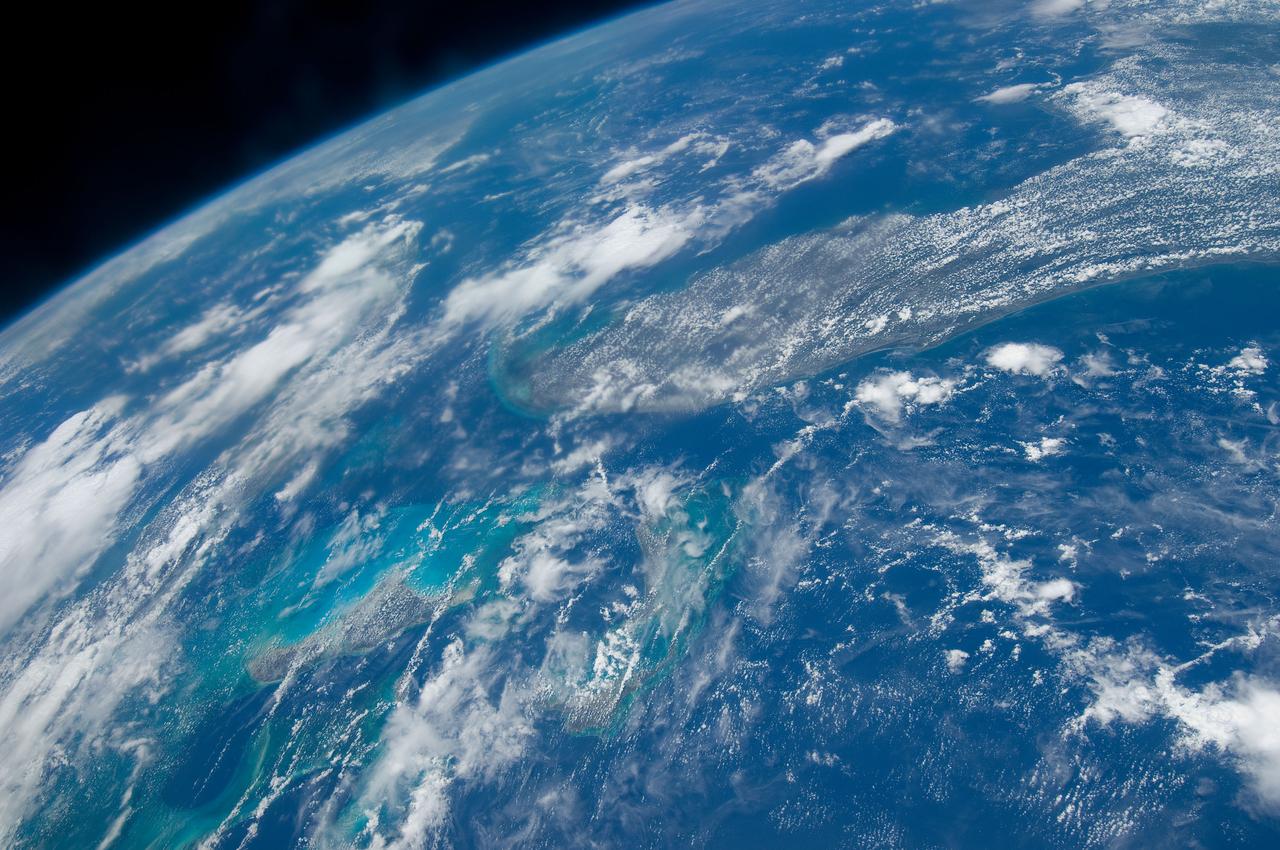 S125-E-007951 (16 May 2009) --- This high oblique Earth scene from the STS-125 crew is reminiscent of Gemini 11 photos 43 years ago,  because of similar altitudes, approximately 350 statute miles. The Florida peninsula and its neighboring geographic features are easily recognizable beneath the clouds along with the tell-tale change in water color associated with the ?Tongue of the Ocean.?