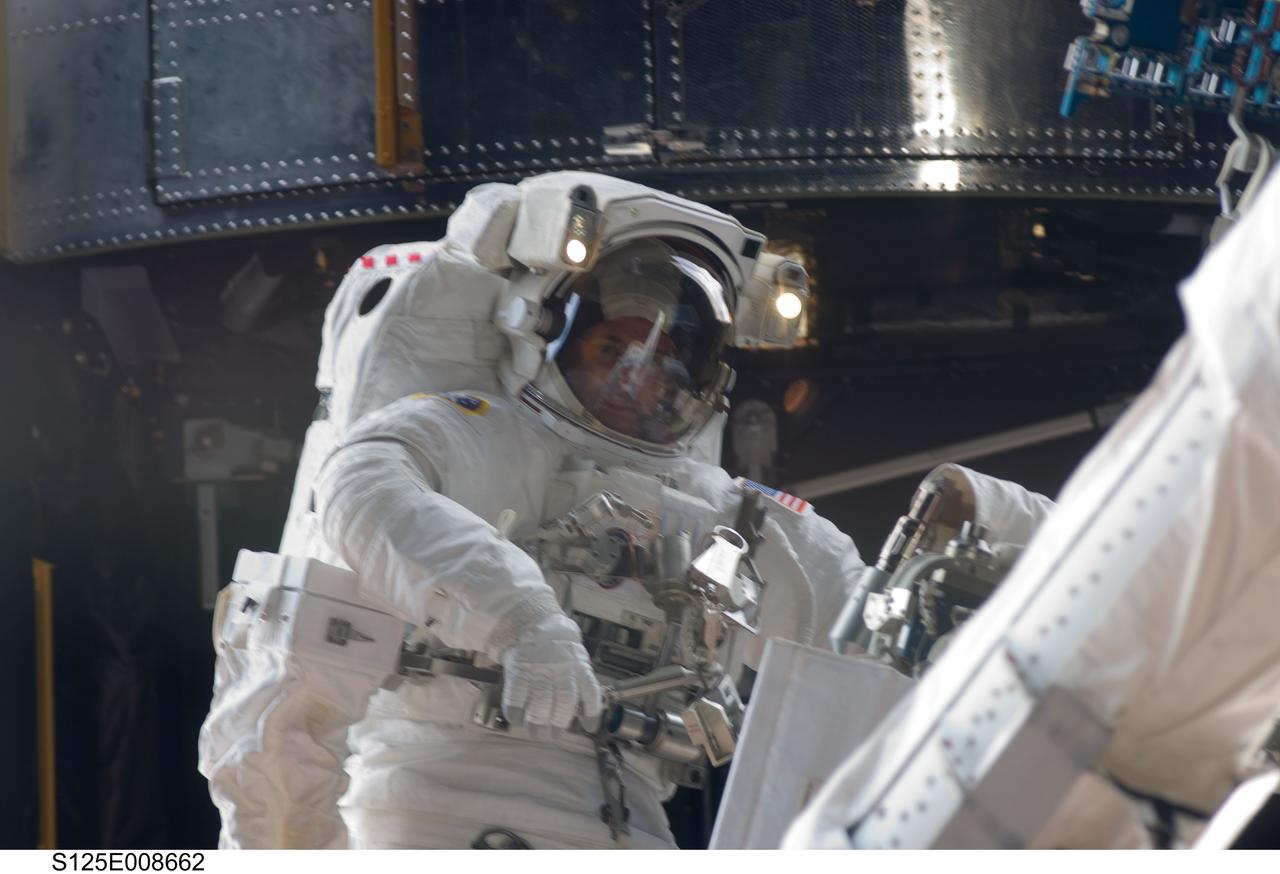 S125-E-008662 (17 May 2009) --- Astronaut Michael Good, STS-125 mission specialist, participates in the mission?s fourth session of extravehicular activity (EVA) as work continues to refurbish and upgrade the Hubble Space Telescope. During the eight-hour, two-minute spacewalk, Good and astronaut Mike Massimino (out of frame), mission specialist, continued repairs and improvements to the Space Telescope Imaging Spectrograph (STIS) that will extend the Hubble?s life into the next decade.