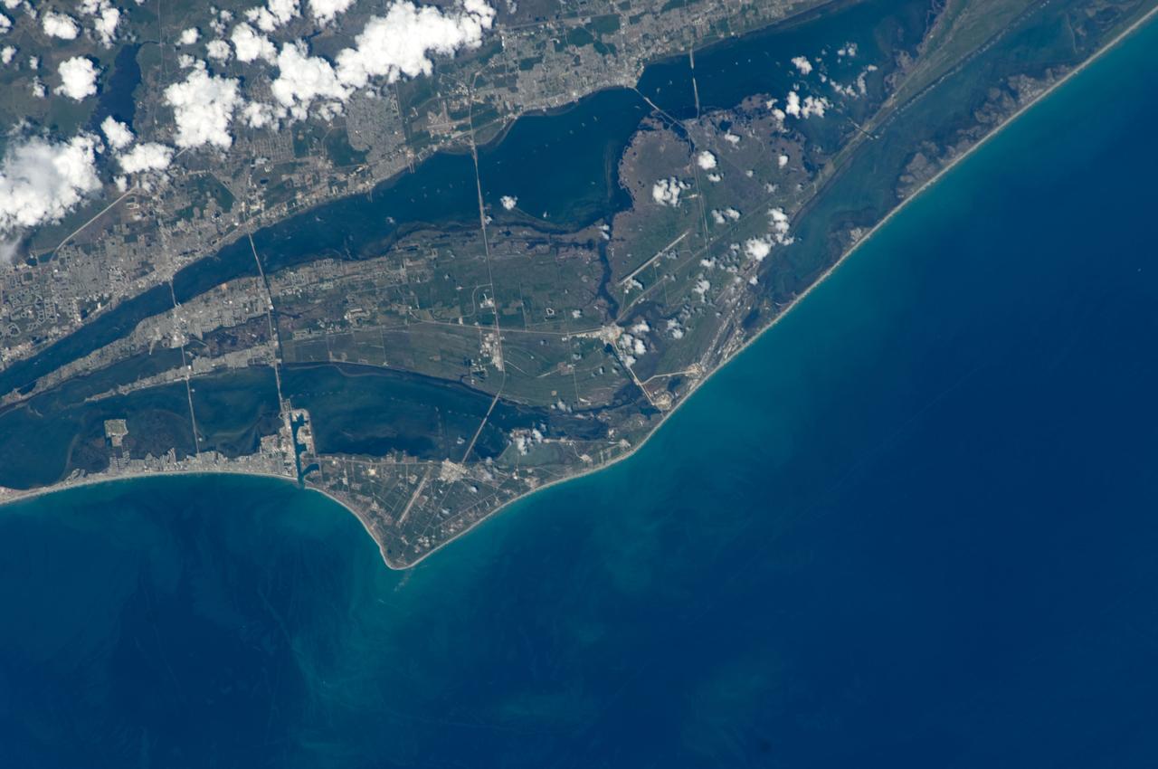 S125-E-008719 (17 May 2009) --- An almost nadir view of the John F. Kennedy Space Center (KSC) was provided by one of the STS-125 crewmembers on the Earth-orbiting Space Shuttle Atlantis. KSC is the NASA space vehicle launch facility and launch control center (spaceport) on Merritt Island, Brevard County, Florida. The site is near Cape Canaveral, between Miami and Jacksonville. It is 34 miles (55 kilometers) long and around 6 miles (10 kilometers) wide, covering 219 square miles (567 square kilometers). Because much of KSC is a restricted area and only 9 percent of the land is developed, the site also serves as an important wildlife sanctuary; Mosquito Lagoon, Indian River, Merritt Island Wildlife Refuge and Canaveral National Seashore are also features of this area. Pictured just below center is Launch Complex 39, with the roadway leading to the giant Vehicle Assembly Building (VAB), 3 miles (5 kilometers) to the west (above) of the two launch pads. Located 5 miles (8 kilometers) south is the KSC industrial area, where many of the Center's support facilities and the administrative Headquarters Building are located. The Shuttle Landing Facility can be seen northwest of the VAB, in frame center.
