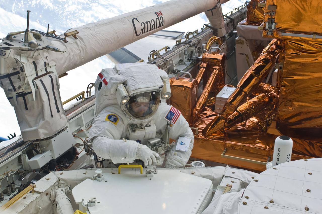 S125-E-008728 (17 May 2009) --- Astronaut Mike Massimino, STS-125 mission specialist, participates in the mission?s fourth session of extravehicular activity (EVA) as work continues to refurbish and upgrade the Hubble Space Telescope. During the eight-hour, two-minute spacewalk, Massimino and astronaut Michael Good (out of frame), mission specialist, continued repairs and improvements to the Space Telescope Imaging Spectrograph (STIS) that will extend the Hubble?s life into the next decade.