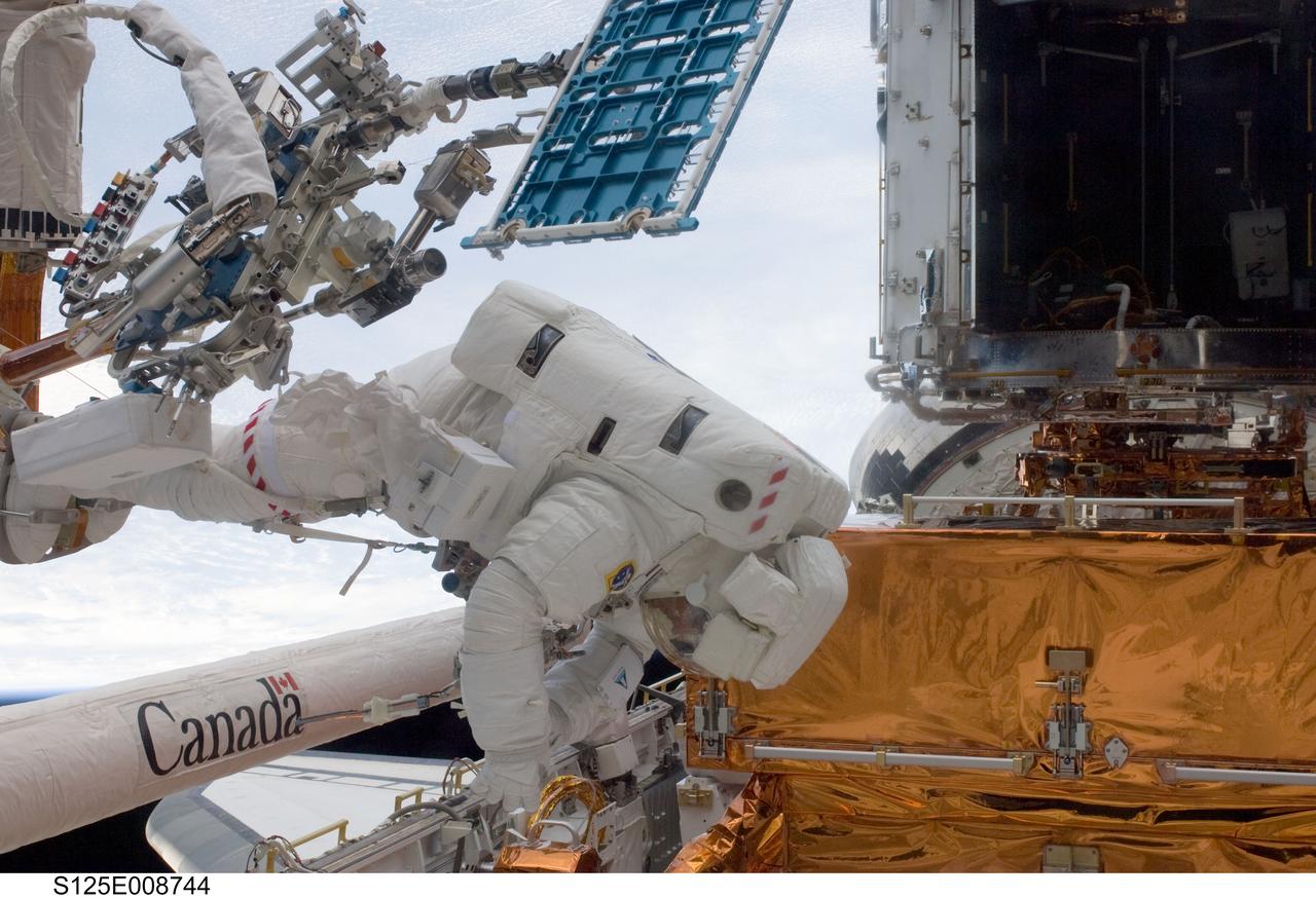 S125-E-008744 (17 May 2009) --- Astronaut Michael Good, STS-125 mission specialist, participates in the mission?s fourth session of extravehicular activity (EVA) as work continues to refurbish and upgrade the Hubble Space Telescope. During the eight-hour, two-minute spacewalk, Good and astronaut Mike Massimino (out of frame), mission specialist, continued repairs and improvements to the Space Telescope Imaging Spectrograph (STIS) that will extend the Hubble?s life into the next decade.